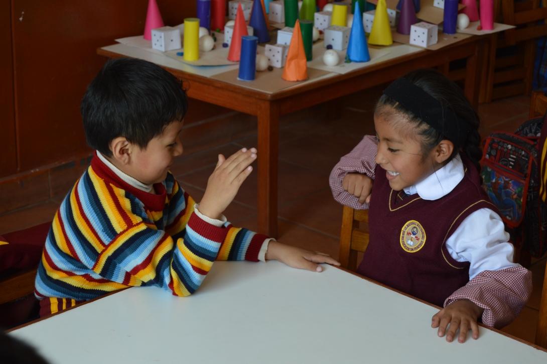 Spring break volunteers watch over their class as the students play games that help them achieve their developmental milestones in Peru. Young students play a game during their early childhood development class in Peru.